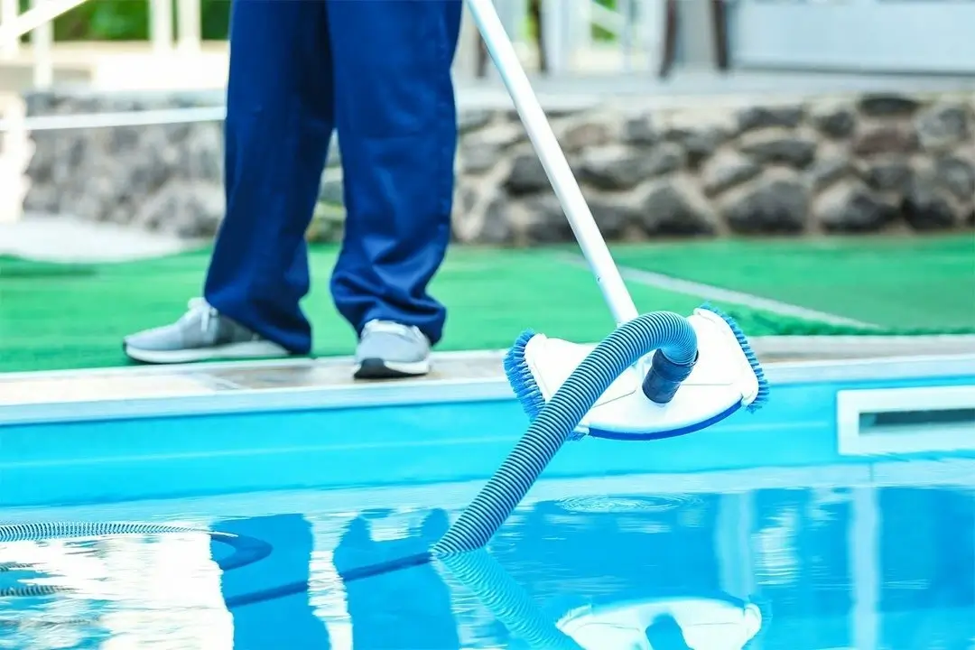 A variety of pool cleaning tools like brushes and nets